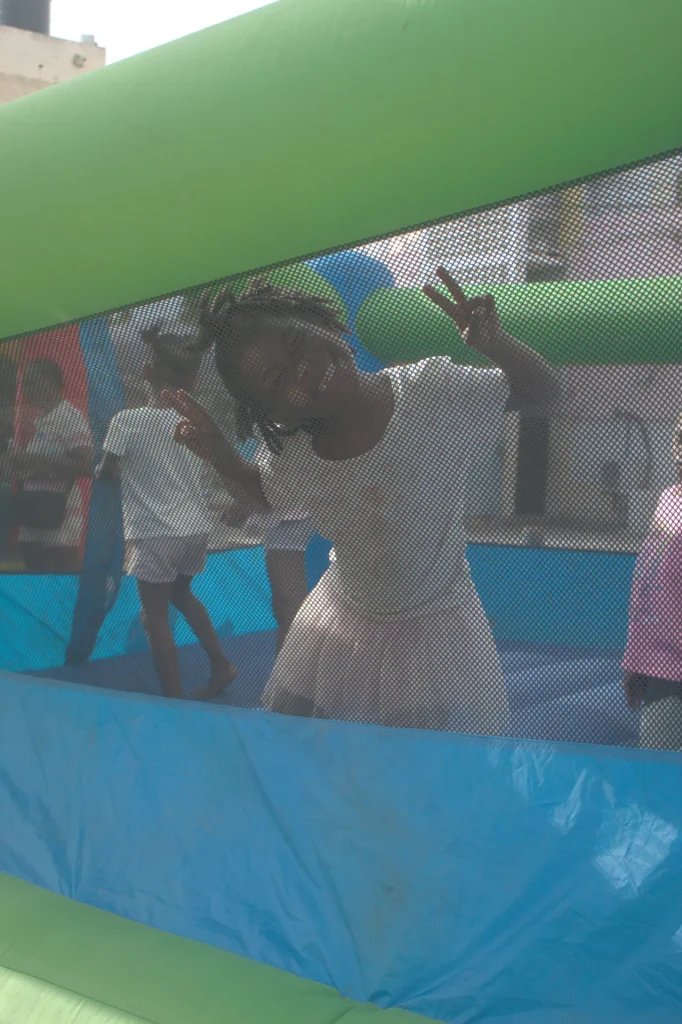 Children playing together inside an inflatable bounce house during the Give Back in Trench Town, Jamaica.