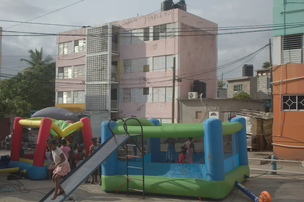 Children playing around an inflatable bounce house during the Give Back in Trench Town, Jamaica.